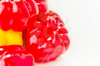 Fresh red and yellow raw pepper on white background