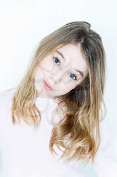 Cute girl eleven years old with blond long hair and green eyes