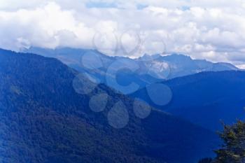 Blue Russian Caucasus mountains landscape with cloudy sky