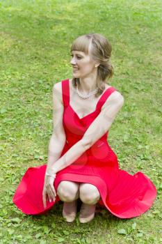 Beautiful lady in red are sitting on ones haunches