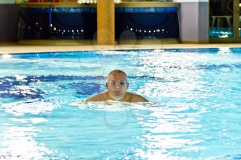 Portrait of big fat man in swimming pool water