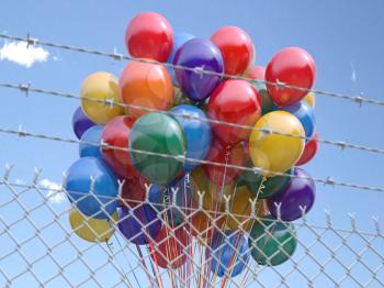 Balloons bunch behind the barbed fence. Freedom or prohibition of celebration concept. 3d illustration