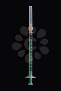 Close-up of syringe isolated on black, medical incstruments