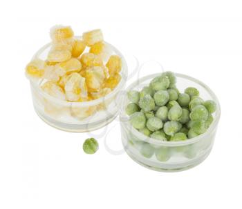 Two small glass cups with frozen corn and peas isolated on white