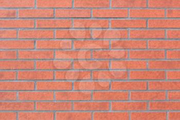 Red brick wall texture. Pattern with narrow brown bricks.