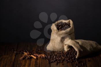 Still-life with coffee, cup with saucer, coffee beans and spices.