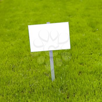 Sign on grass whith isolated space for caption