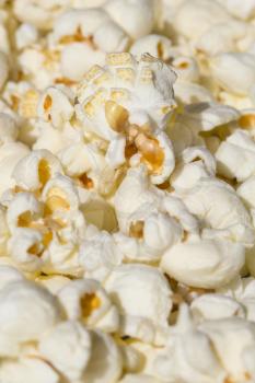 Scattered salted popcorn, food texture background. Fastfood popular during a movie in a cinema
