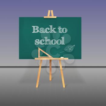 Green school board with chalk on a tripod and an inscription Back to School