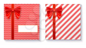 Gift boxes with big red bow and ribbon, isolated on white background. Top view on gift packaged in a paper with pattern and copy-space place for your text