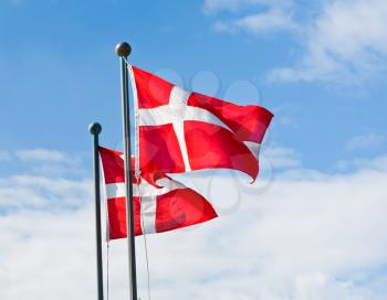 danish flags with blue sky on background