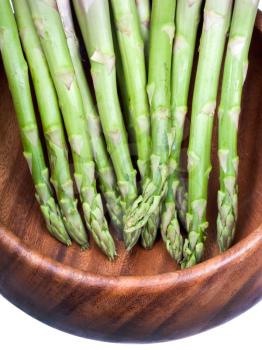 green asparagus in wooden bowl