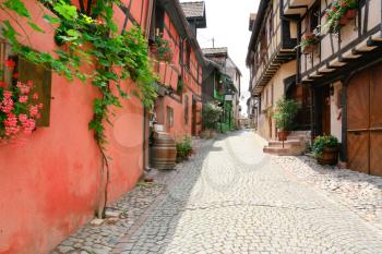 alley in medieval Riquewihr town on wine route Alsace. Riquewihr known for the Riesling and other great wines produced in the village.