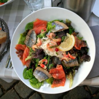 lunch  - plate of big salad with with salmon and herring