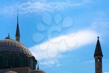 muslim minaret and mosque silhouette on blue sky background