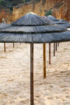 straw beach umbrellas, Portugal, Algarve