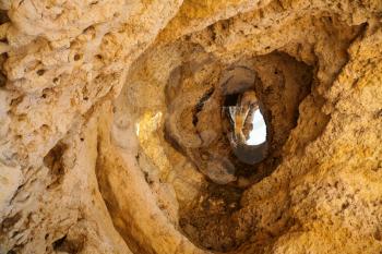 hole in shell limestone mountain, Algarve, Portugal
