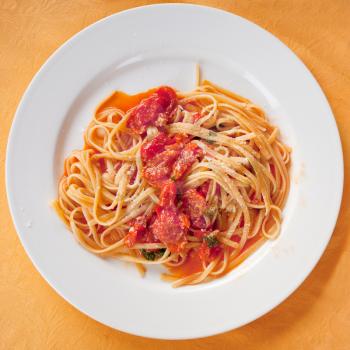 spaghetti with spicy tomato sauce on white plate 