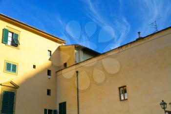 yellow walls of house and blue sky