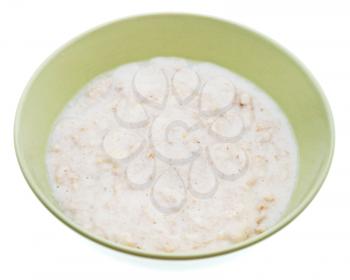 traditional english oat porridge with milk in ceramic bowl isolated on white background