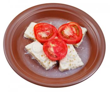 fresh sliced tomatoes and brined cheese on plate isolated on white background