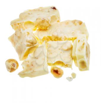 top view of broken white chocolate with hazelnuts isolated on white background