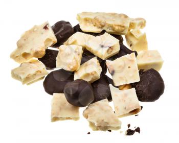 mix from candies of plums in dark chocolate and white chocolate with hazelnuts isolated on white background