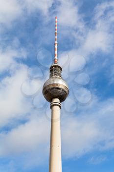Fernsehturm TV tower spire with blue cloudy sky in Berlin