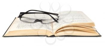 eyeglasses on open book isolated on white background