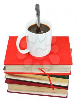 mug of coffee on stack of books isolated on white background