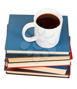 above view mug of coffee on stack of books isolated on white background