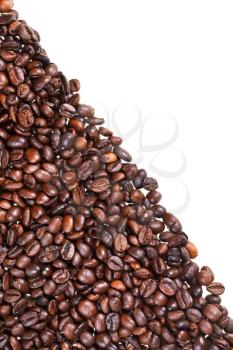 slope from roasted coffee beans close up on white background