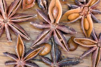 macro view of illicium seeds spice on wooden table