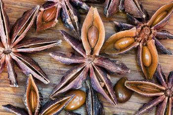 dried anise seeds spice on wooden table close up