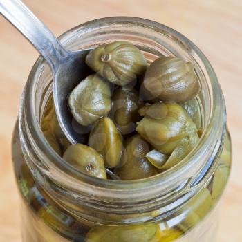 top macro view of pickled capers in glass jar