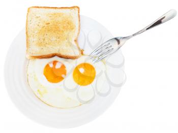 fresh toast and two fried eggs on white plate isolated on white background