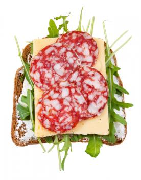 sandwich from brown bread, salami, cheese and green salad isolated on white background