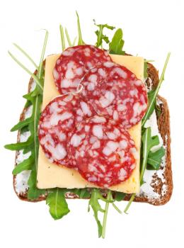 sandwich from brown bread, salami, cheese and fresh rucola isolated on white background
