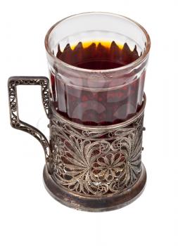 hot black tea in vintage glass with nickel silver glass-holder isolated on white background