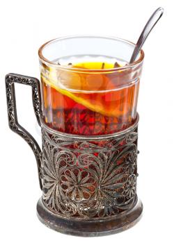 black tea with lemon in retro glass with teaspoon and glass-holder isolated on white background