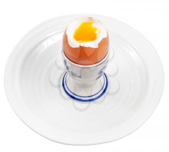 Light boiled egg in egg cup on white plate isolated on white