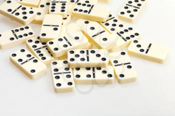 scattered dominoes on white background close up