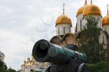 view of Tsar Cannon and gold dome of Kremlin Cathedrals in Moscow