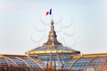 french state flag on Great Palace in Paris in evening