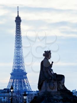 statue Marseille on place de la Concorde and Eiffel Tower in Paris at sunset