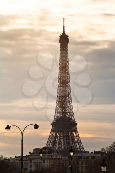 urban lamps and eiffel tower in Paris at yellow sunset