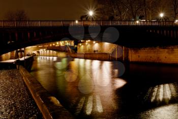 pont au Double and Seine river in Paris at night