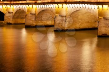 Pont Neuf through Seine river in Paris at night