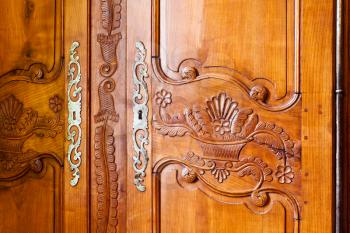 carved wooden door of old wardrobe