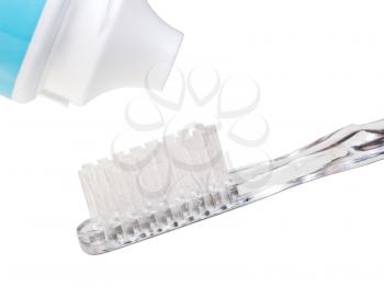 toothpaste tube and toothbrush close up isolated on white background